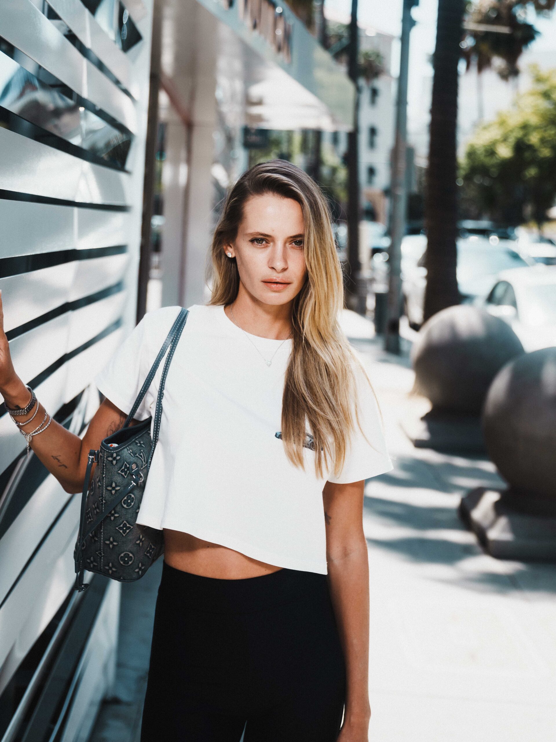 Confident female model portrait on Rodeo Drive Beverly Hills with luxury storefront background photographed by Johnny Hann