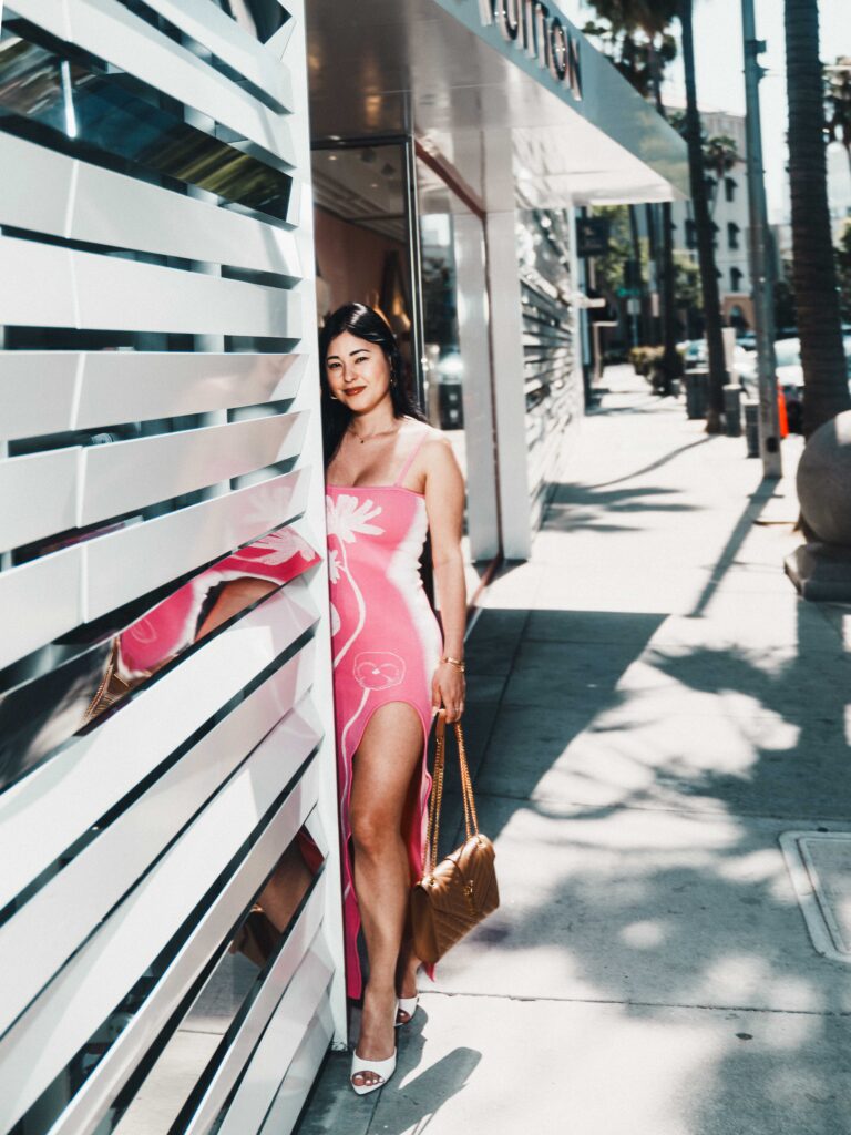 Tammy Veneza in pink dress posing by Louis Vuitton Beverly Hills wall, luxury street fashion editorial by Johnny Hann