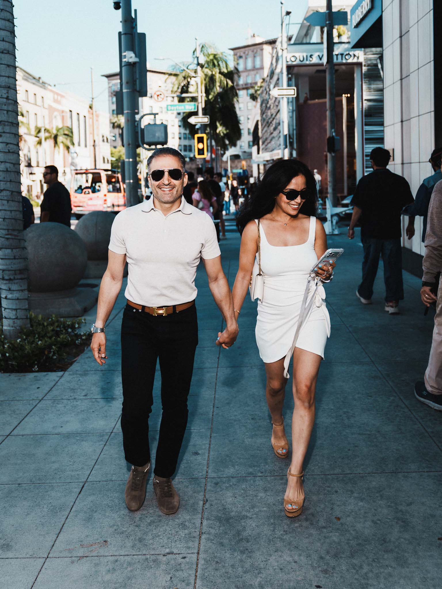 Sonia Mans CEO baby food founder walking on Rodeo Drive Beverly Hills with partner luxury street editorial by Johnny Hann Photo near Louis Vuitton